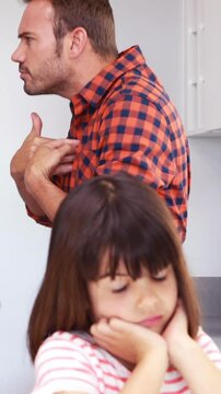 Couple arguing in front of their daughter