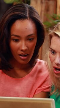 Surprised friends looking at tablet