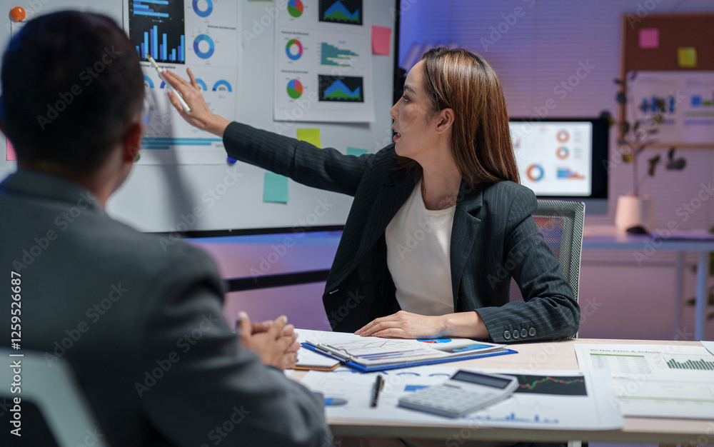 Poster businesswoman presenting data analysis on a digital screen in a modern office setting. colleagues en