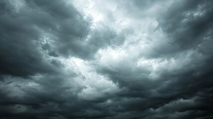 Obraz premium Dramatic Gray Clouds Overcast Sky Before Stormy Weather Approaching with Mysterious Atmosphere and Intense Dark Tones