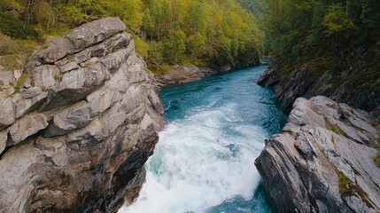 Obraz premium Scenic Aerial View of Bright Blue River Flowing Through Rocky Canyon