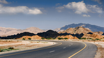 Scenic Desert Highway Curving Through Rugged Mountains.