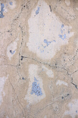 Texture of an old peeling wall with cracks and abrasions.
