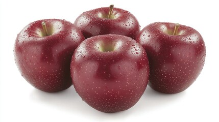 Four fresh red apples with droplets of water, arranged on a white background, ideal for food photography