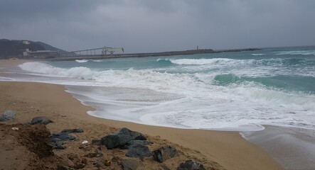 waves breaking on th coastline with white foam in korea