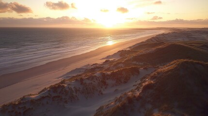 Fototapeta premium Serene sunset over sandy dunes and ocean waves, capturing tranquil nature and scenic beauty