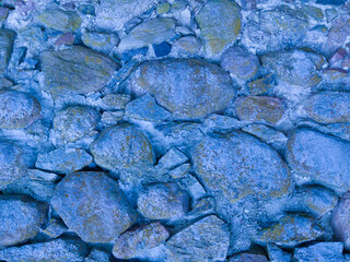 An old stone wall. Background of blue stones. Stone texture. Blue stones.