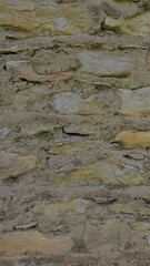 An old grey stone wall. Grey stone background. Stone texture. Old masonry.