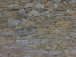 An old grey stone wall. Grey stone background. Stone texture.