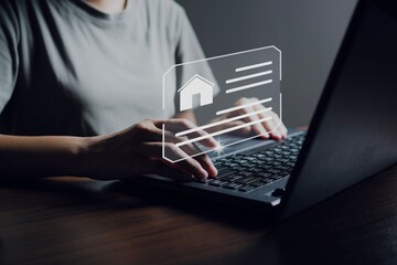 Business woman use a computer to find information about buying and selling a house.