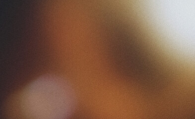 Abstract background with a grainy texture forming a gradient from brown to black