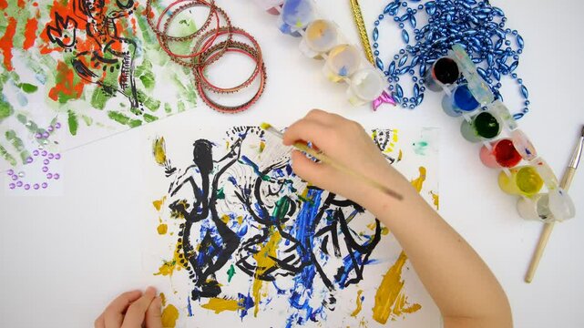 Child creativity. Painting with mixed media with abstract lines paints, abstract silhouettes dancing girls in an Indian costume, freehand lines 