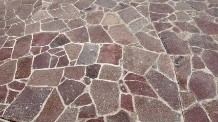 Stone pathway design with various textures and colors in sunlight