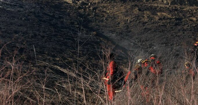Brea, California, USA - October 3, 2021: Incarcerated Firefighters walk on a fire line fighting a wildfire.