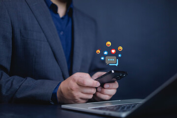 Social media and digital online, man using smart phone use social media network application, Friend reply chat concept or send emoticon for react feeling, playing Social media Distancing.