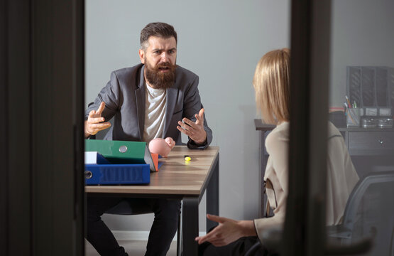 Angry boss shouting at an employee. Office conflict. Frustrated secretary dealing with a rude boss. Nervous employee facing an angry manager. Boss screaming in frustration. Office conflict.