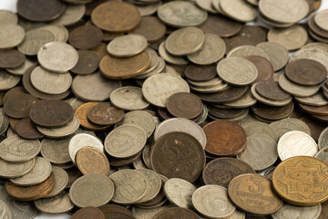 Coins different countries are scattered on table closeup.