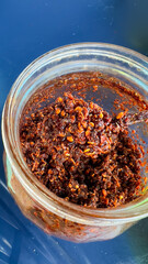 Karen Chili Paste, a chili paste used in noodles to add a spicy flavor to Thai boat noodles. Chili paste in a glass bottle.