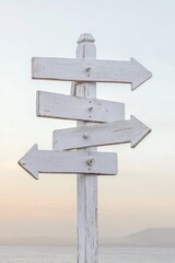 Wooden directional signs by the sea at sunrise