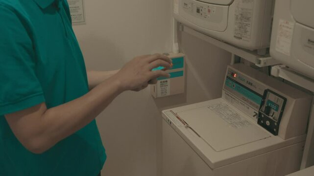 A person interacts with a washing machine's control panel, highlighting the modern design and user-friendly interface. The image captures a moment in daily life, emphasizing the convenience of home ap