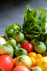 Vegetables in a basket on a dark background. Healthy food.