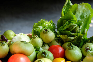 Vegetables in a basket on a dark background. Healthy food.