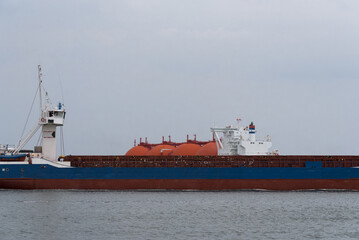 MARITIME TRANPSORT - LNG tanker in the background and a merchant vessel in the foreground