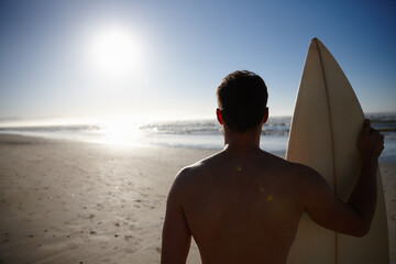 Back, holiday and sports with surfer on beach in summer for fitness, hobby or training in...