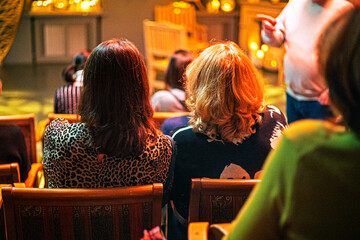 girls are having a discussion in the conference hall at a themed Halloween party