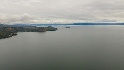 Large lake Lanao and rain clouds view from above. Mindanao, Lanao del Sur, Philippines.