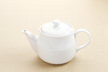 Small ceramic teapot with handle, kitchen utensil

