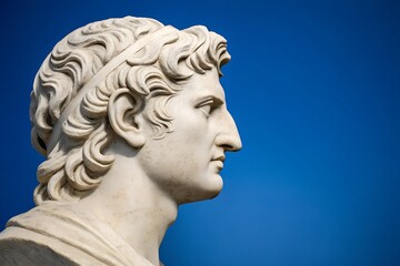  Greek marble bust in profile. Copy space. Bright blue background complements the neoclassical details.