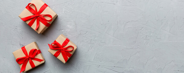 Valentine day composition: red gift box with bow and heart. Christmas present. View from above....