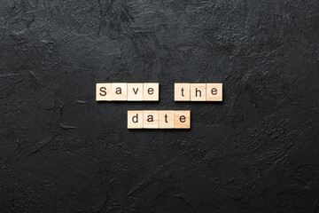 Save the Date word written on wood block. Save the Date text on table, concept