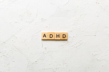 ADHD word written on wood block. ADHD text on table, concept