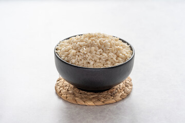 Arborio rice close up on grey background. White short grain rice close up on grey background. 