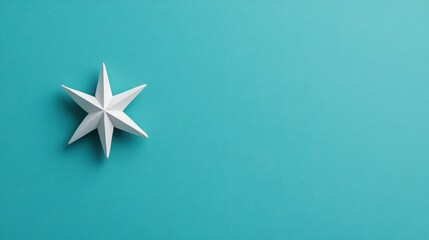 A beautifully crafted white paper star on a vibrant turquoise background, perfect for holiday or decorative themes.