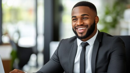 Fototapeta premium Professional Man in Suit Smiling at Desk with Laptop Computer