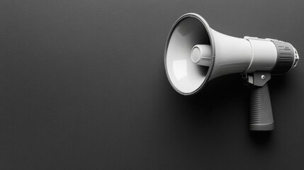 Grey Megaphone Positioned Against a Dark Textured Background for Public Announcements