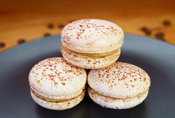 Closeup of Stack of Delectable Tiramisu Macarons on a Black Plate