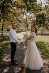 bride and groom walking in park