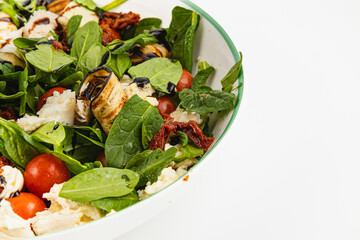 Fresh spinach salad with grilled vegetables and cheese for a healthy meal