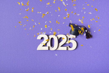 Wooden number 2025 with graduated cap on purple background with tinsel