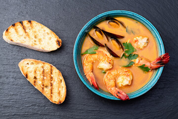 French seafood bouillabaisse soup with shrimps and mussels photography . Top view