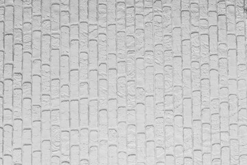 Textured white brick wall with a modern design and subtle shadows