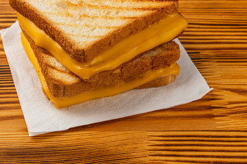 Delicious grilled cheese sandwich on wooden table ready for breakfast or lunch