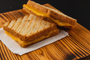 Delicious grilled cheese sandwich on wooden platter for brunch or snack