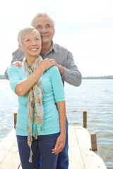 Love, travel and senior couple at lake for loyalty, strong relationship and connection on holiday....