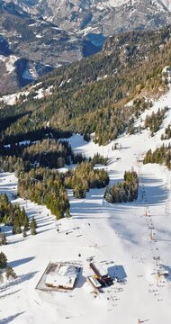 Aerial drone view of a ski resort in Col dei Baldi, Alleghe, in the Dolomites, Italy in daylight. Vertical