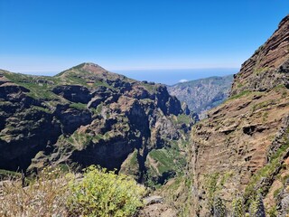 Incredible mountain landscape view, hike from Pico do Arieiro to Pico Ruivo, Madeira, steep cliffs and deep valleys, vibrant blue sky